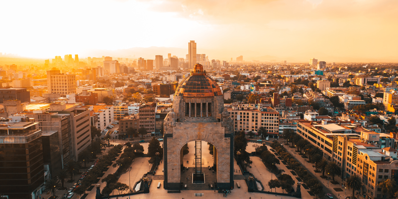 Aerial view of the Monumento a la Revolución and the Mexico City skyline at sunset — The Mexico Move Kit